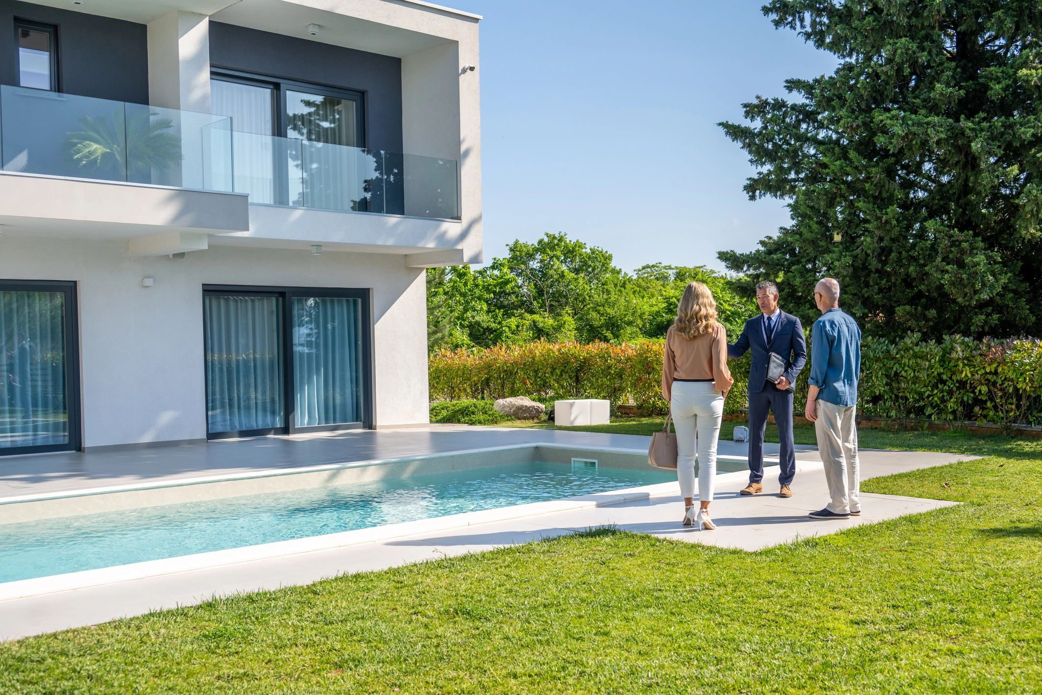 Modern luxury home exterior shown during a client consultation